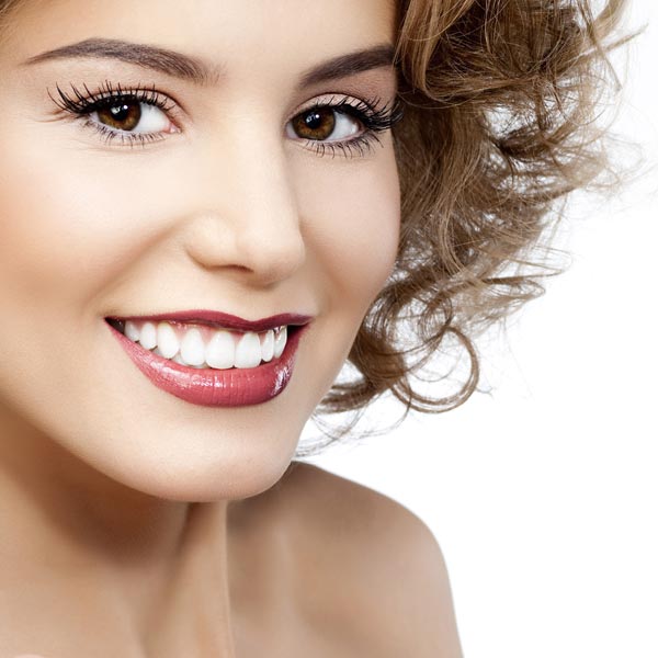 woman with curly hair and perfect smile
